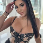 Mary Yousefi (@itsmimipeach) in a figure-hugging brown long sleeve dress