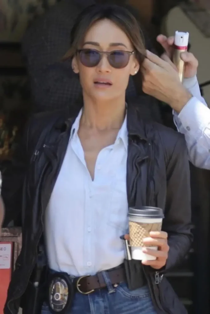Maggie Q performing a barbell squat during weight training